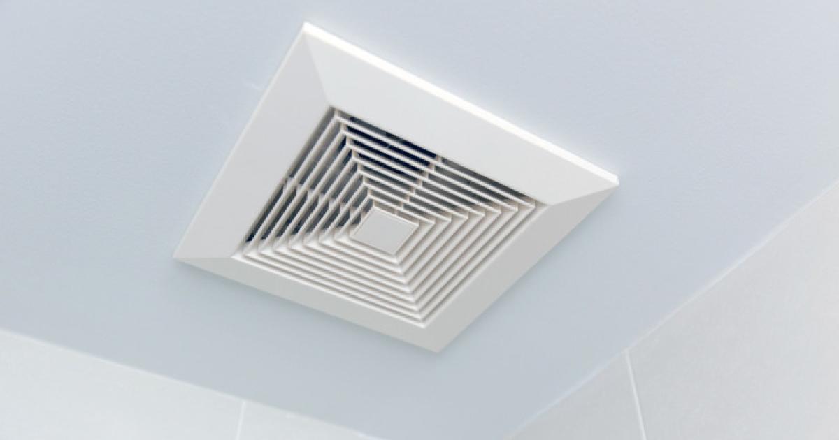 Čistý, bílý kryt koupelnového ventilátoru bez prachu namontovaný zpět na strop